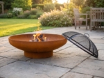 36 in. corten steel fire bowl with a wood fire on a flagstone patio