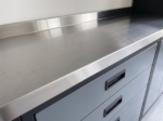 Close-up of the stainless worktop edge and recessed handle