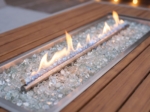 Close-up of the linear burner, fire glass and teak-look border