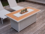 Rectangular fire table with its lid on, used as a coffee table