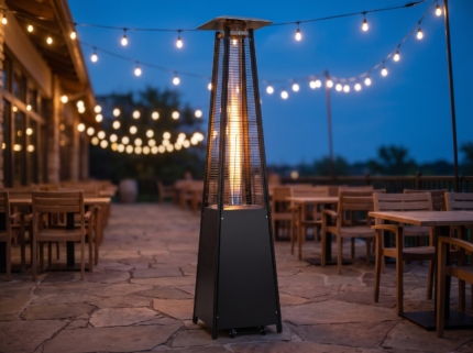 87 in. matte black pyramid patio heater glowing on a stone patio at blue hour