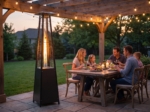 Glass-tube patio heater beside an outdoor dining table with string lights