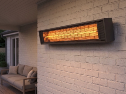 Wall-mounted infrared patio heater glowing on a covered porch